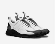 White and black sneakers on a light gray background