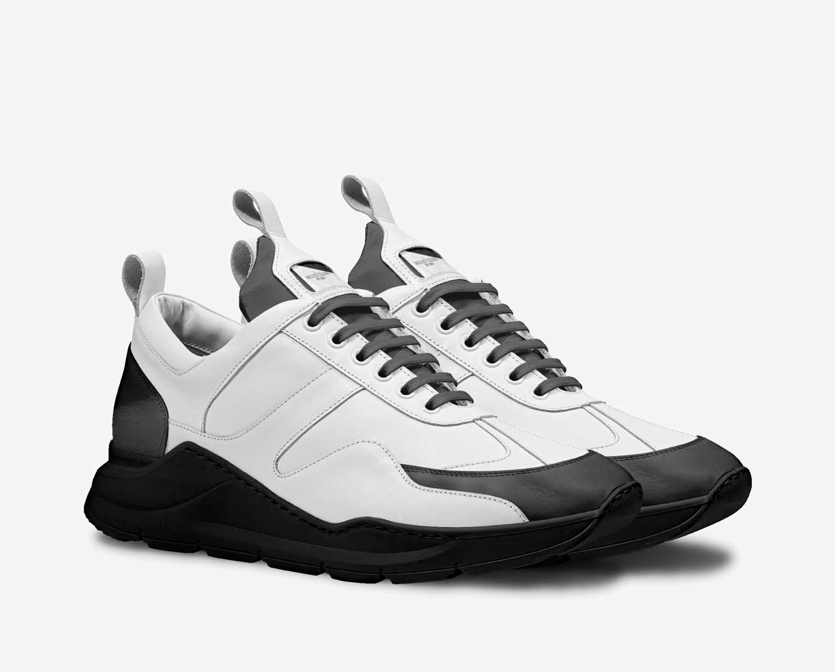 White and black sneakers on a light gray background