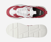 White and red sneaker with a focus on sole design on a white background