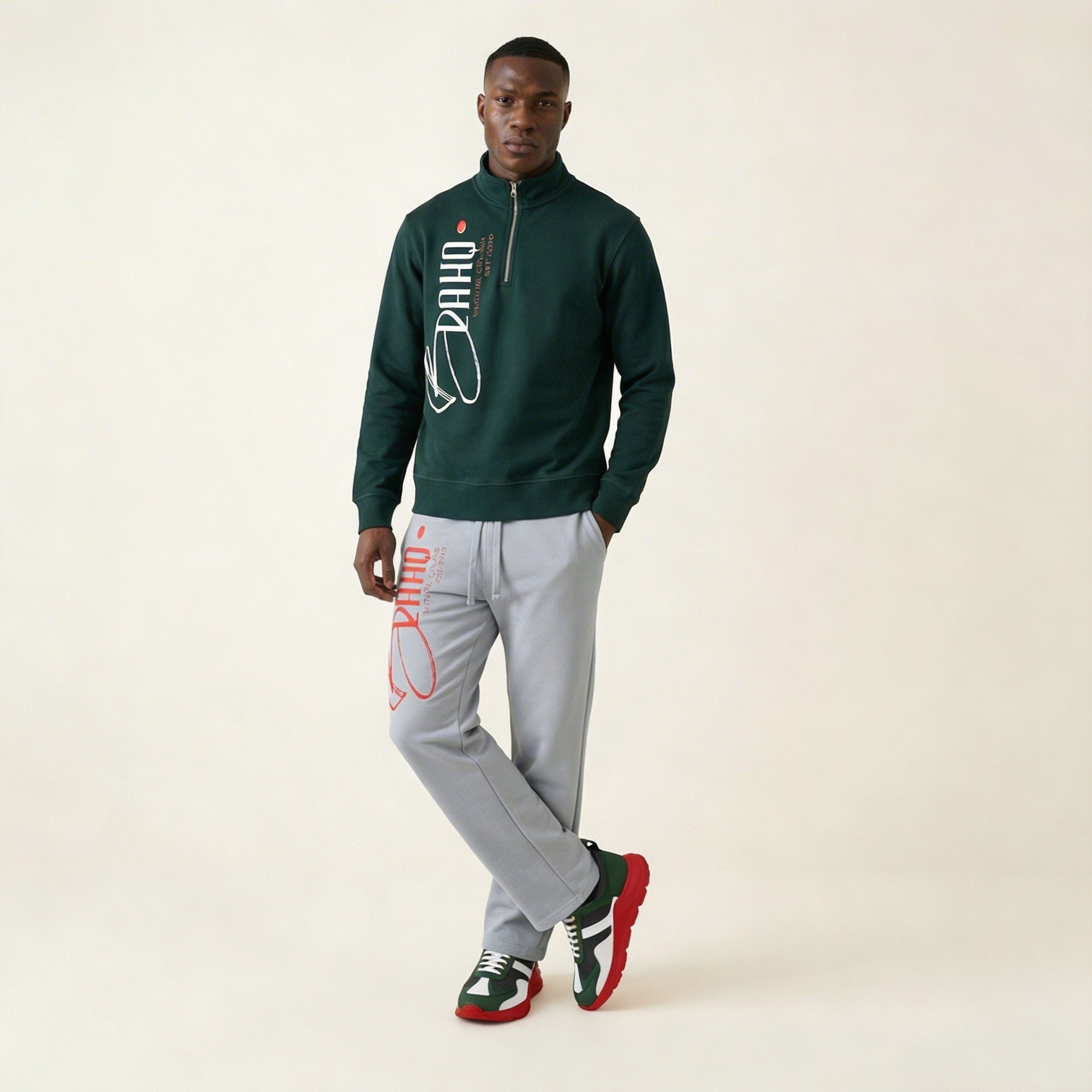 Man wearing a green jacket and gray pants with Puma branding on a beige background