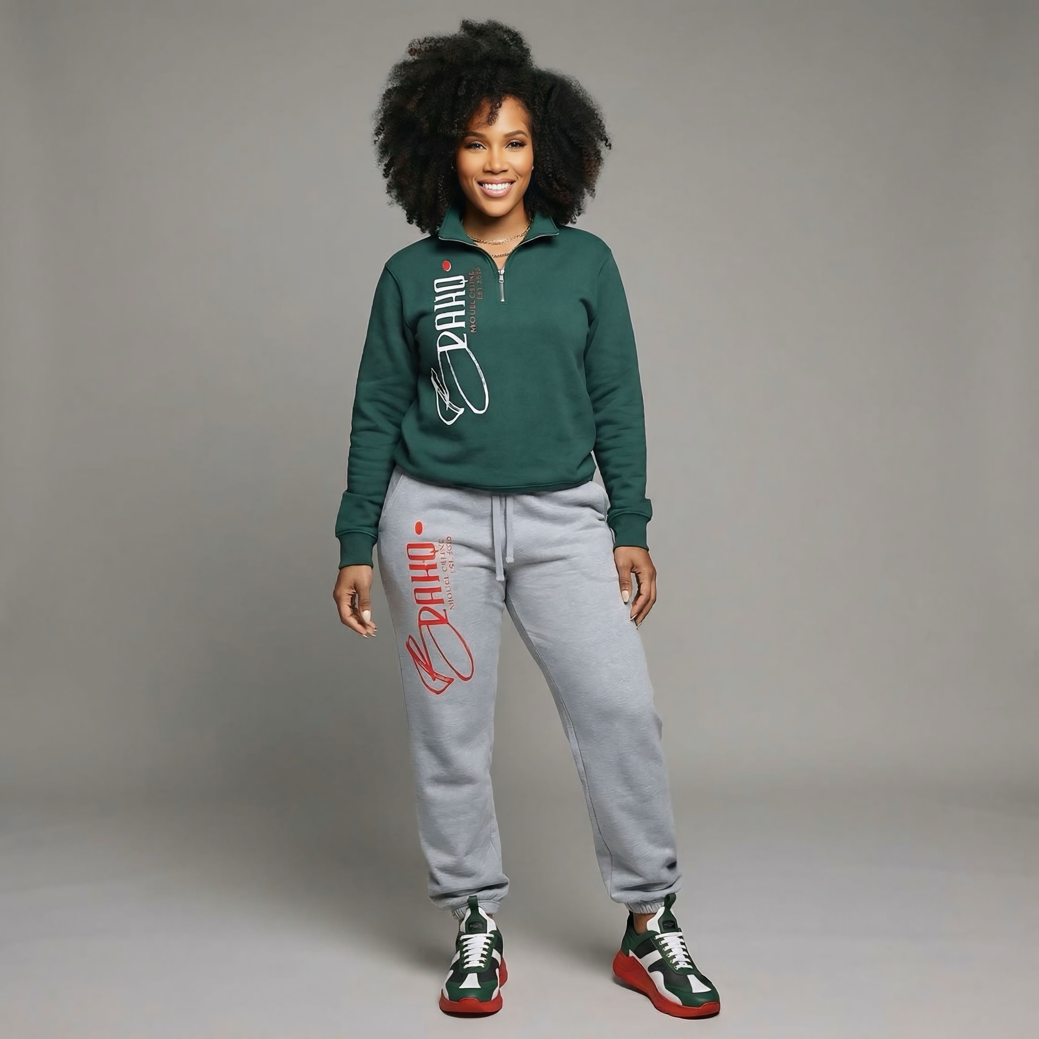 Woman wearing a green sweatshirt and gray sweatpants with red text on a gray background