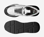 White sneaker with black sole on a light gray background